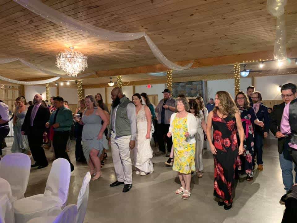 Guests dancing at Mountain Ridge Venue wedding reception with elegant decor.
