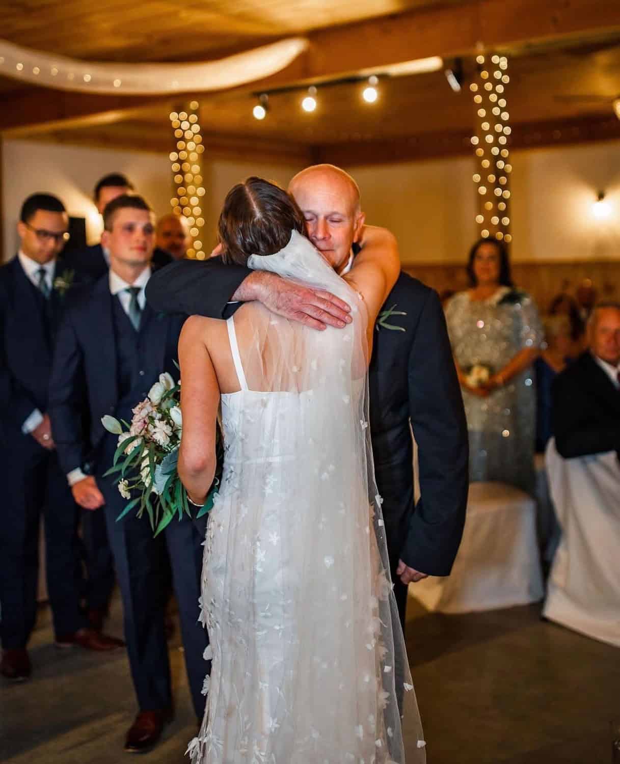 Bride and groom sharing a heartfelt hug at Mountain Ridge Venue wedding.