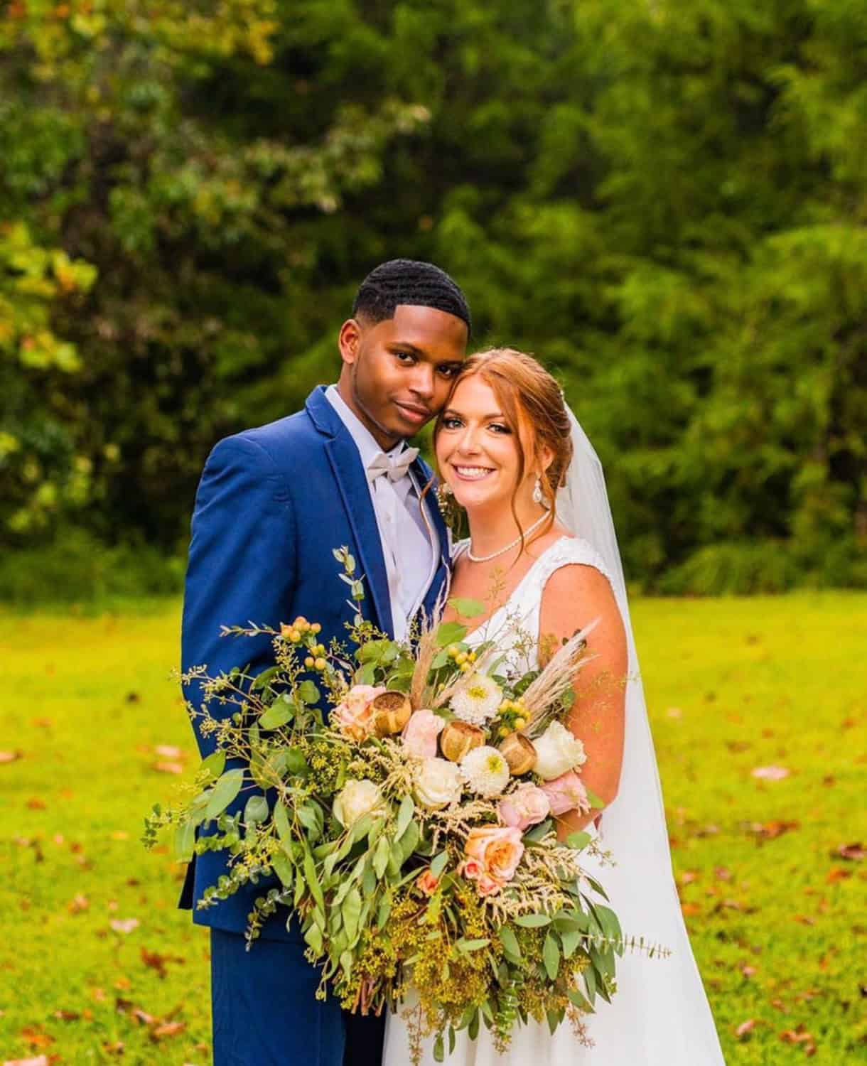 Beautiful wedding couple at Mountain Ridge Venue with lush green background.