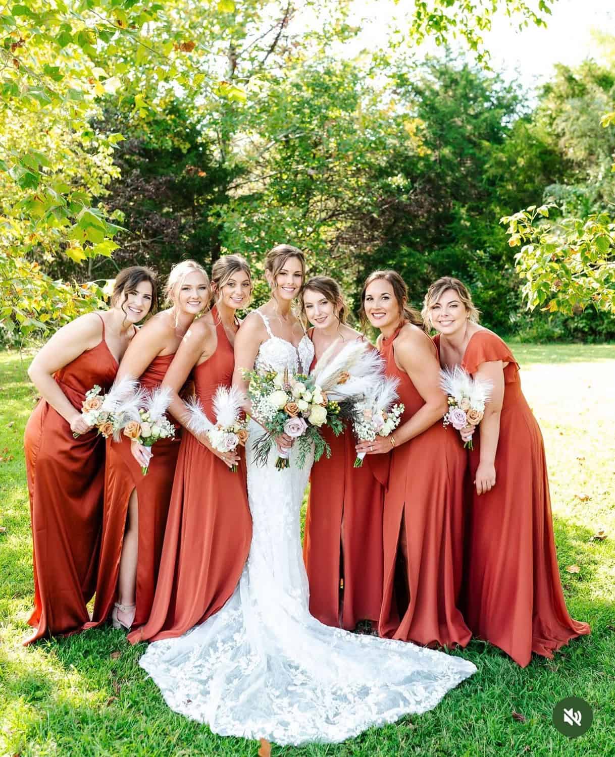 Bridal party in matching rust-colored dresses at Mountain Ridge Venue.