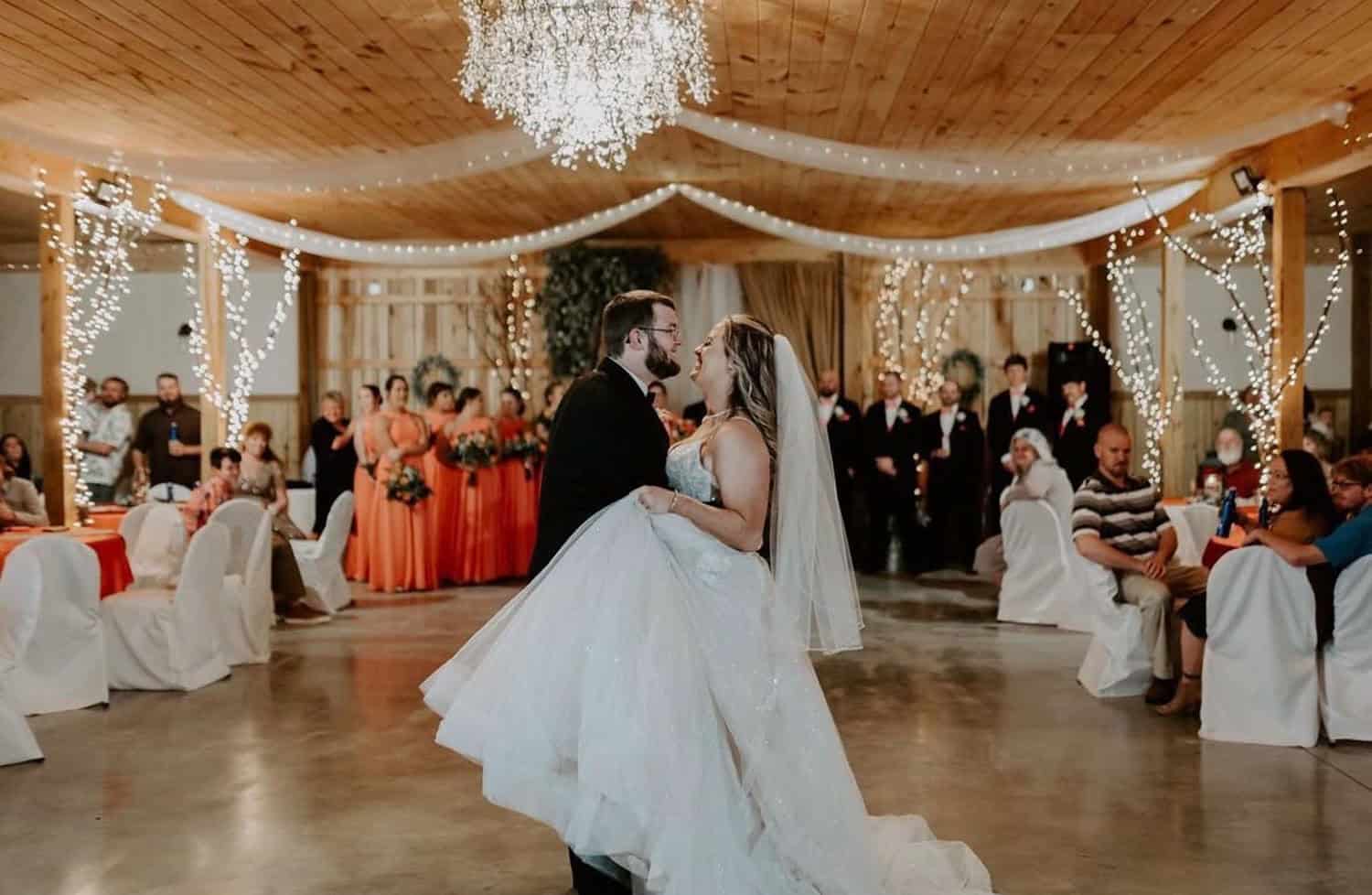 Couple dancing at Mountain Ridge wedding venue decorated with fairy lights.