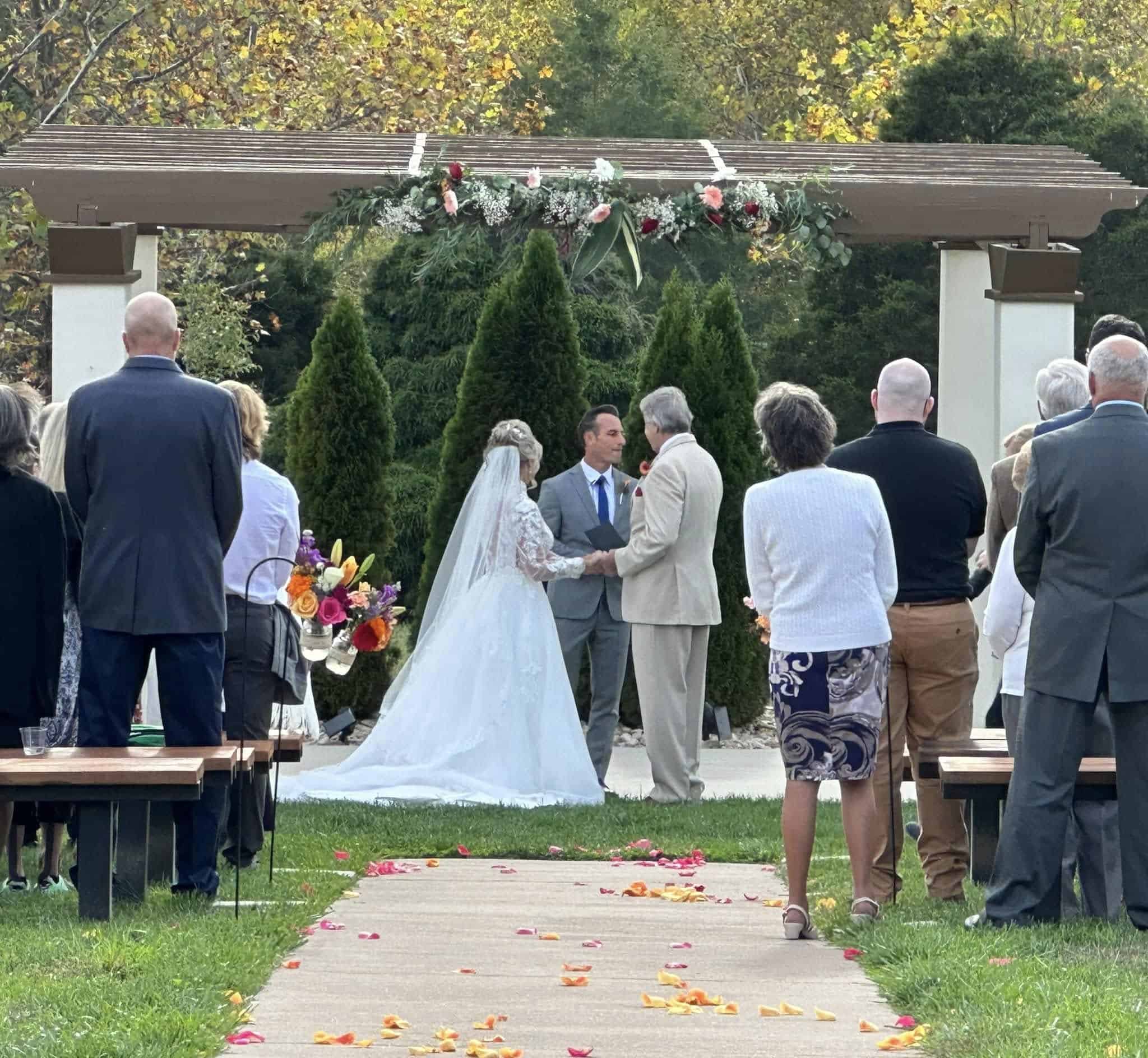 Wedding ceremony at Mountain Ridge Venue with couple and guests outdoors.