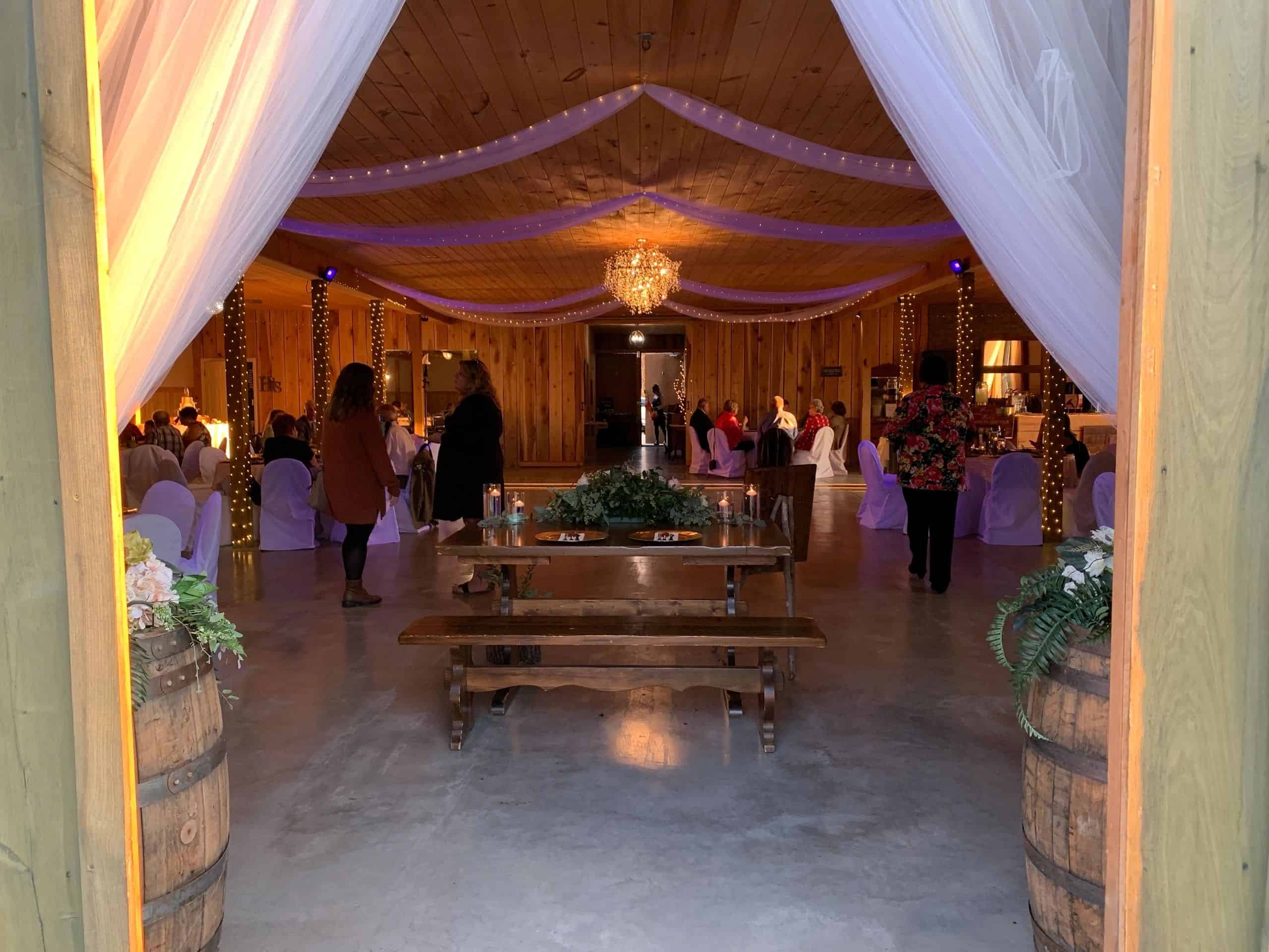 Elegant event space at Mountain Ridge Venue with draped ceilings and chandelier.
