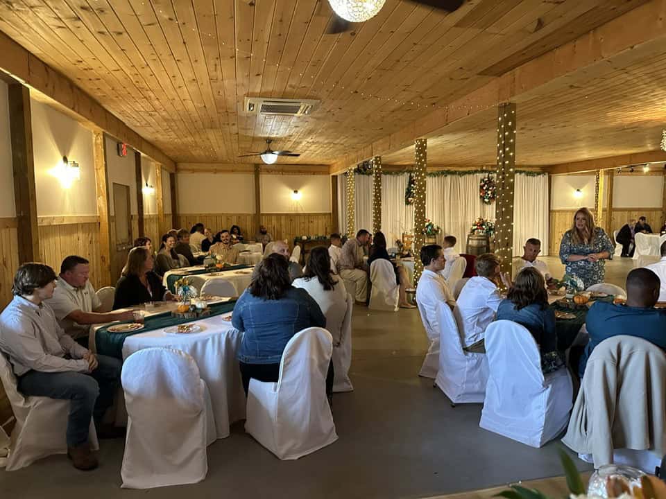 Indoor event space at Mountain Ridge Venue with guests seated at tables.