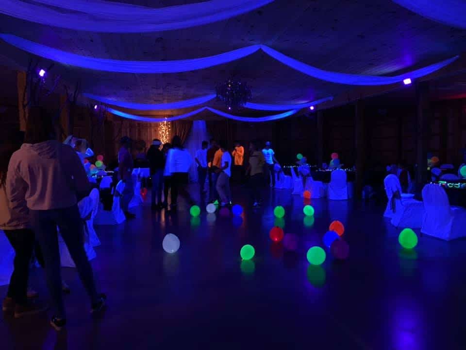 Indoor event space at Mountain Ridge Venue with colorful lighting and glowing balls on the floor.