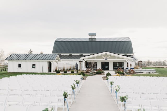 Scenic Mountain Ridge venue with outdoor seating and modern barn-style building.