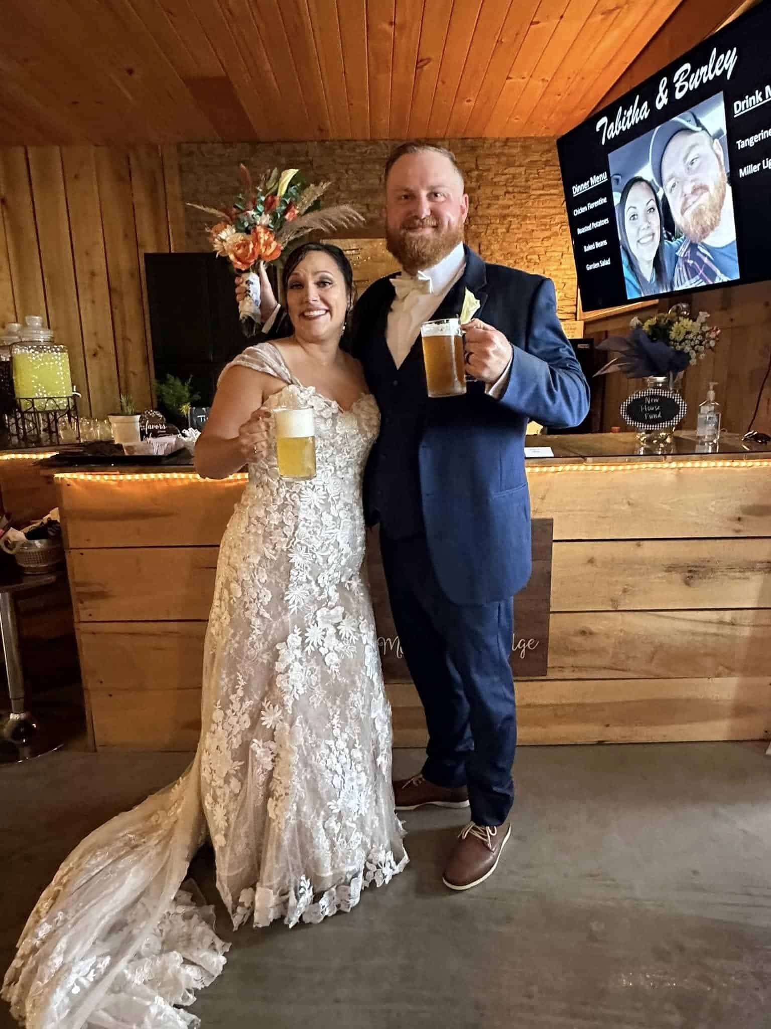 Happy bride and groom with drinks at Mountain Ridge Venue.